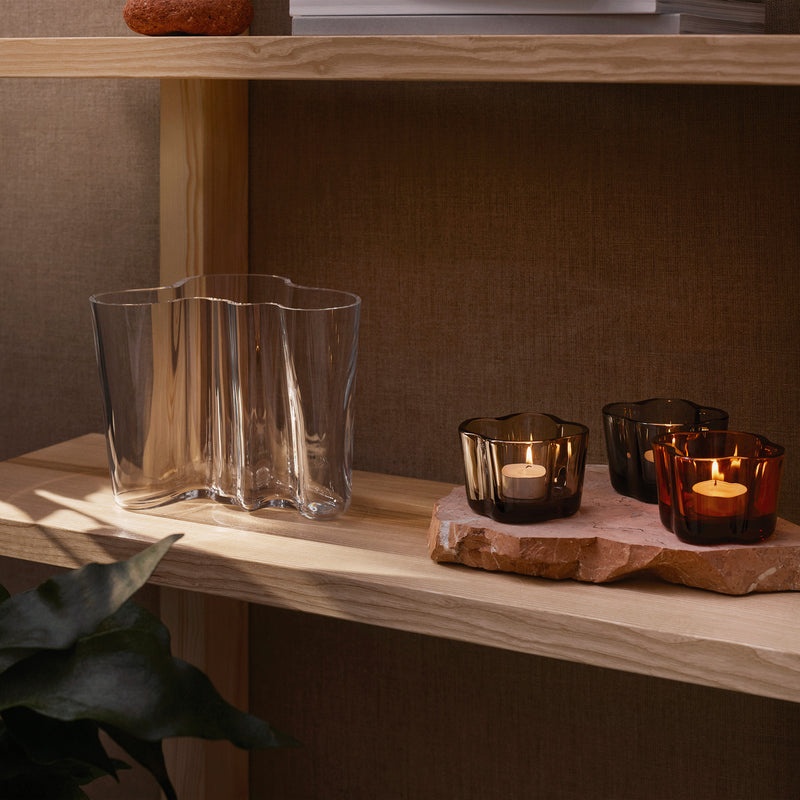 iittala Alvar Aalto Clear Vase on shelf accented by candleholders