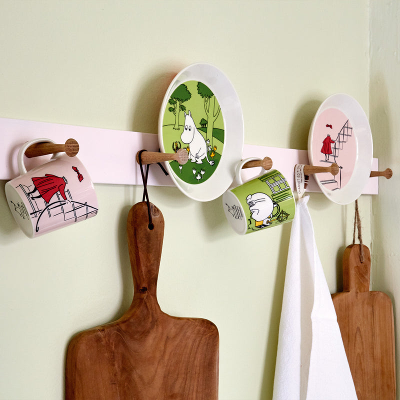 Arabia moomin dinnerware displayed on wall