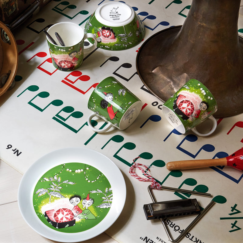Arabia Moomin Thingumy & Bob dinnerware placed on table with music sheet