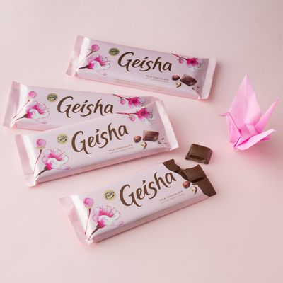 Four geisha chocolate bars on pink background
