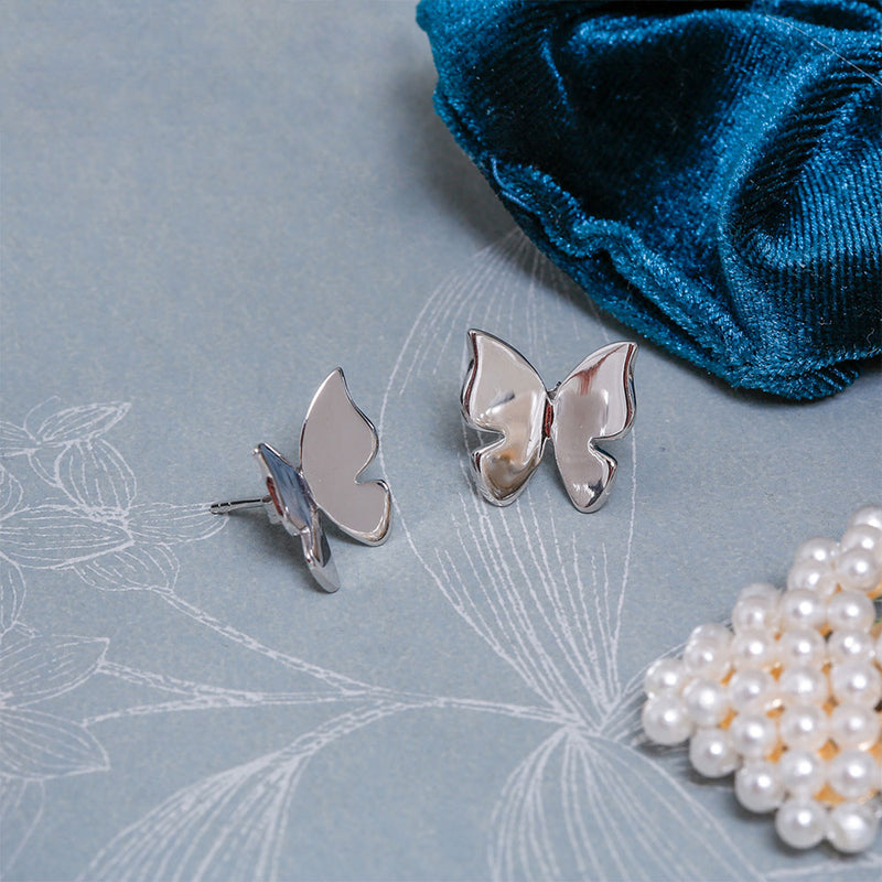 Finnfeelings Butterfly Silver Earrings on blue table