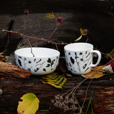 Vallila Flower Mug and bowl placed on log in woods