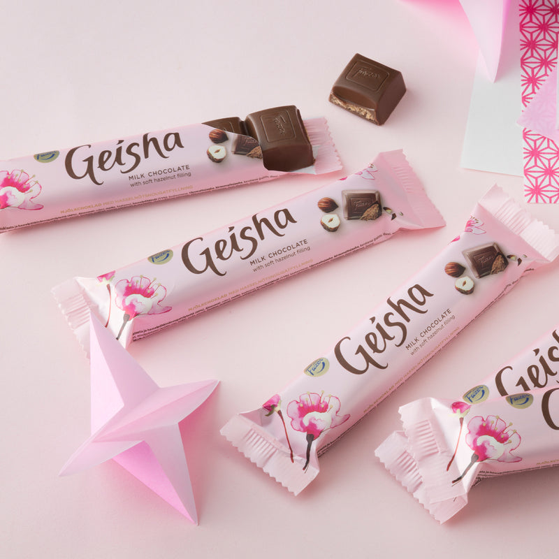Multiple Fazer Geisha Milk Chocolate Bars on pink background