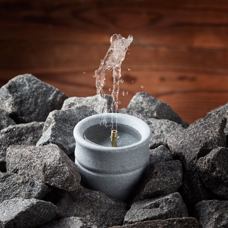 Hukka Sauna Soapstone Water Fountain / Scent Diffuser nestled in sauna rocks spouting water