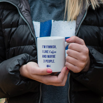 person holding I'm Finnish, I like Coffee And Maybe 3 People Coffee Cup in both hands