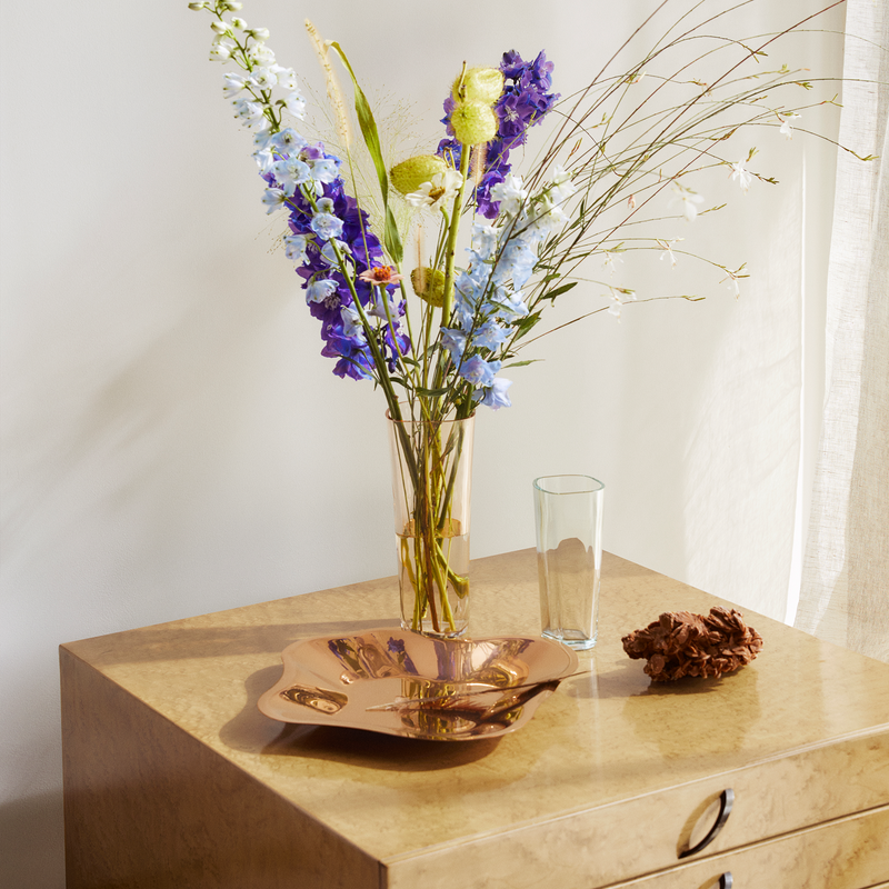 aalto vases with flowers on nightstand