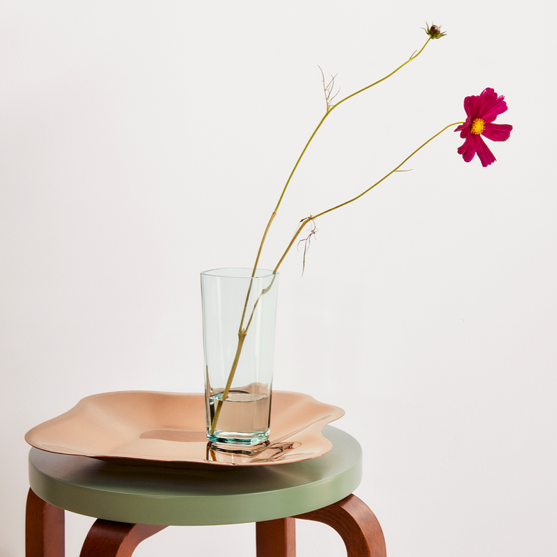iittala Alvar Aalto 1937 Clear Vase 7" with two flowers sitting on stool