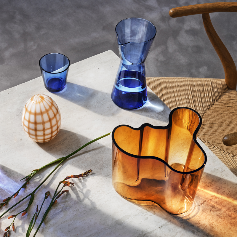 Ultramarine Blue tumbler and pitcher on table with copper vase 