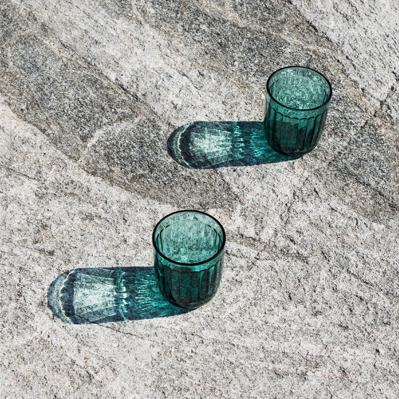 Two Sea Blue Raami tumblers on rock surface