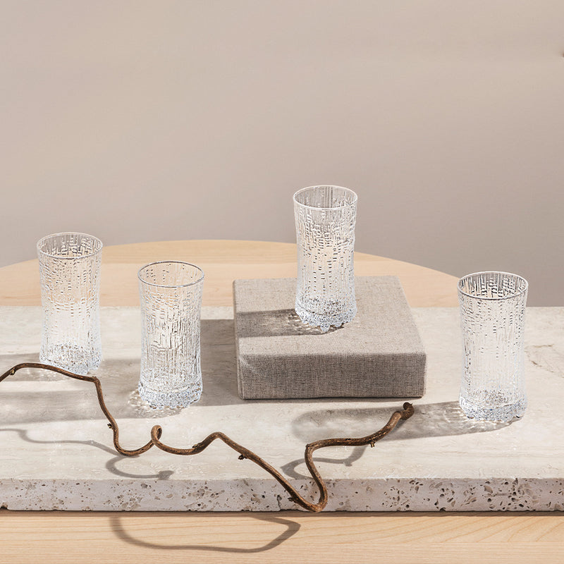 Four Ultima Thule Champagne glasses displayed on table