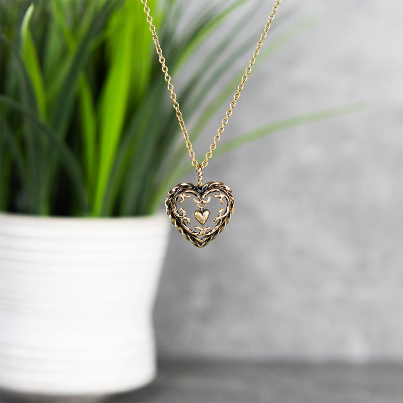 Kalevala Heart of the House Bronze Necklace with plant in background