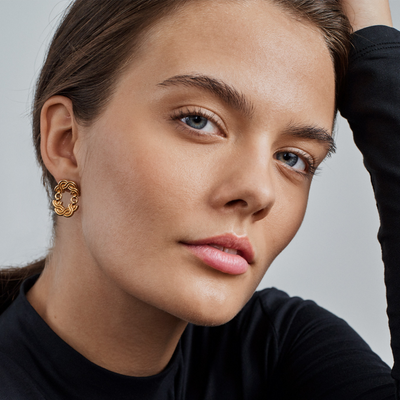 model with black top gazing while wearing Maiden of the North earring