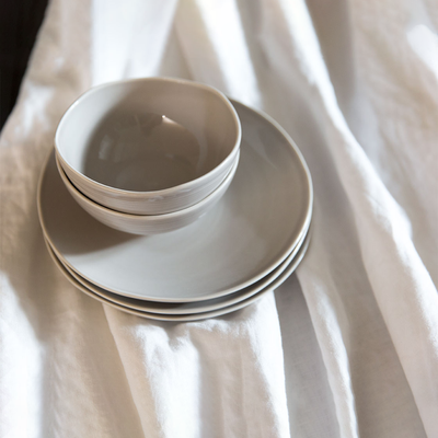 Stack of Kallio grey salad plates with two bowls 