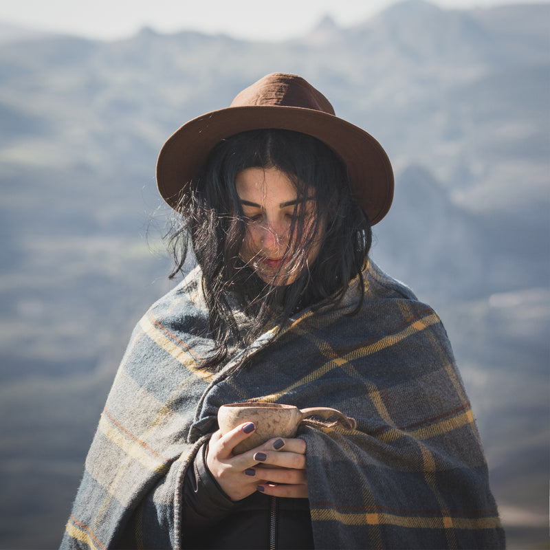 Woman warming up with hot coffee in Kupilka cup