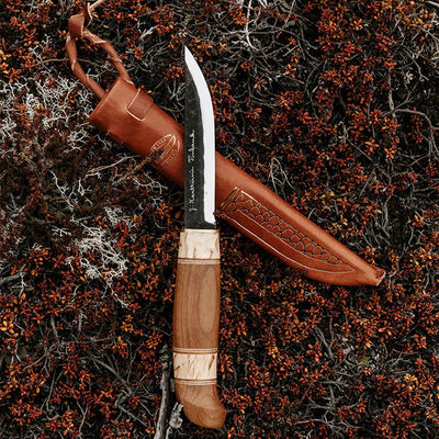 Marttiini Kierinki Knife and sheath in bush with red flowers