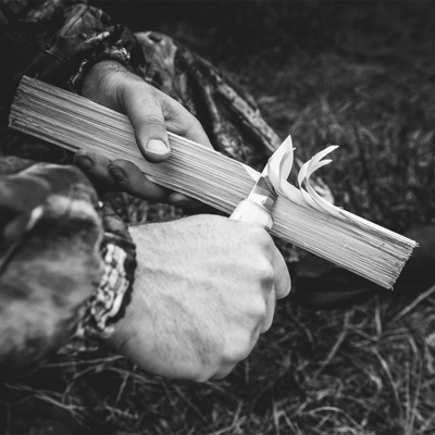 Using Marttiini Handy Knife to shave kindling from firewood