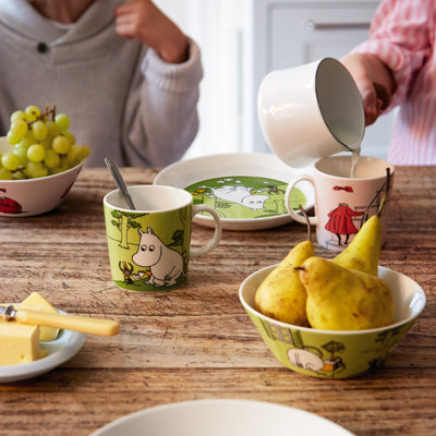 mom and child using arabia moomin dinnerware during breakfast