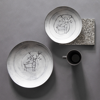 Two Pentik Posio plates with mug on table