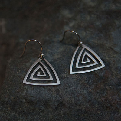 Pohjolan Helmi Trio Spiral Earrings on rocky surface