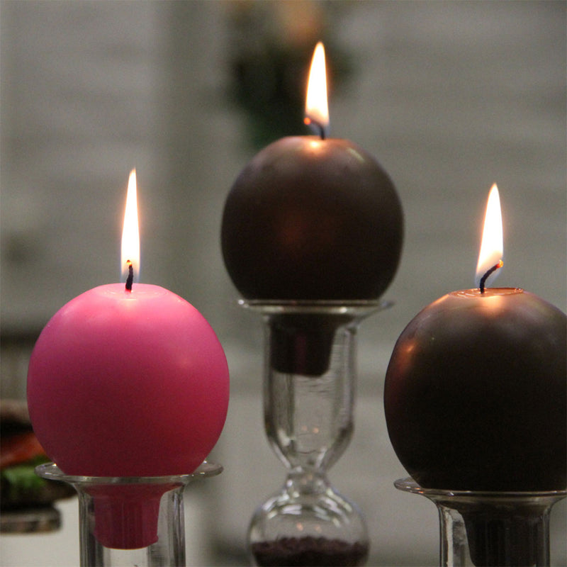 Lit Finnish Footed Ball Candles set in candleholders