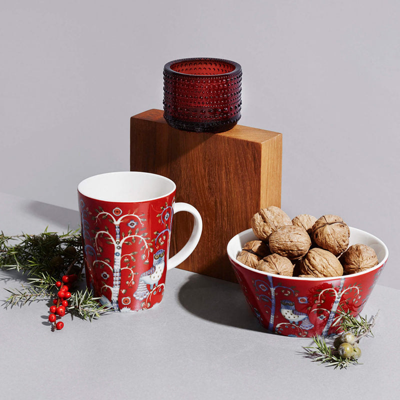 grouping of iittala holiday dinnerware and votive