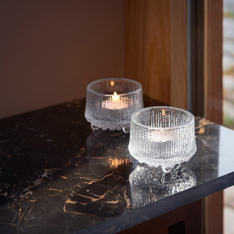 Two Ultima Thule Candleholders on table