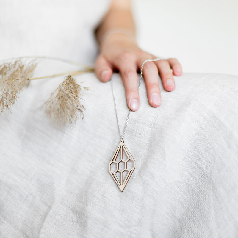 Holding Valona Diamond Birch Necklace, Natural in hand