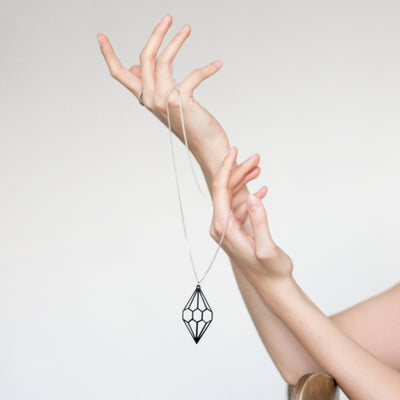 Valona Diamond Birch Necklace dangling from persons hands