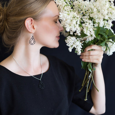 Woman in black top wearing Valona Drop Birch jewelry