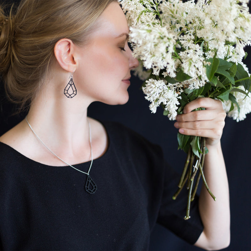 Woman in black top wearing Valona Drop Birch jewelry