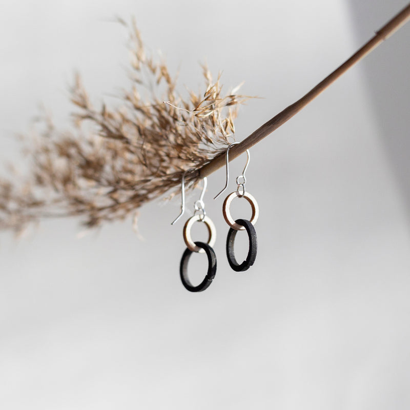 Valona Mini Halo Birch Earrings hanging on dried up branch